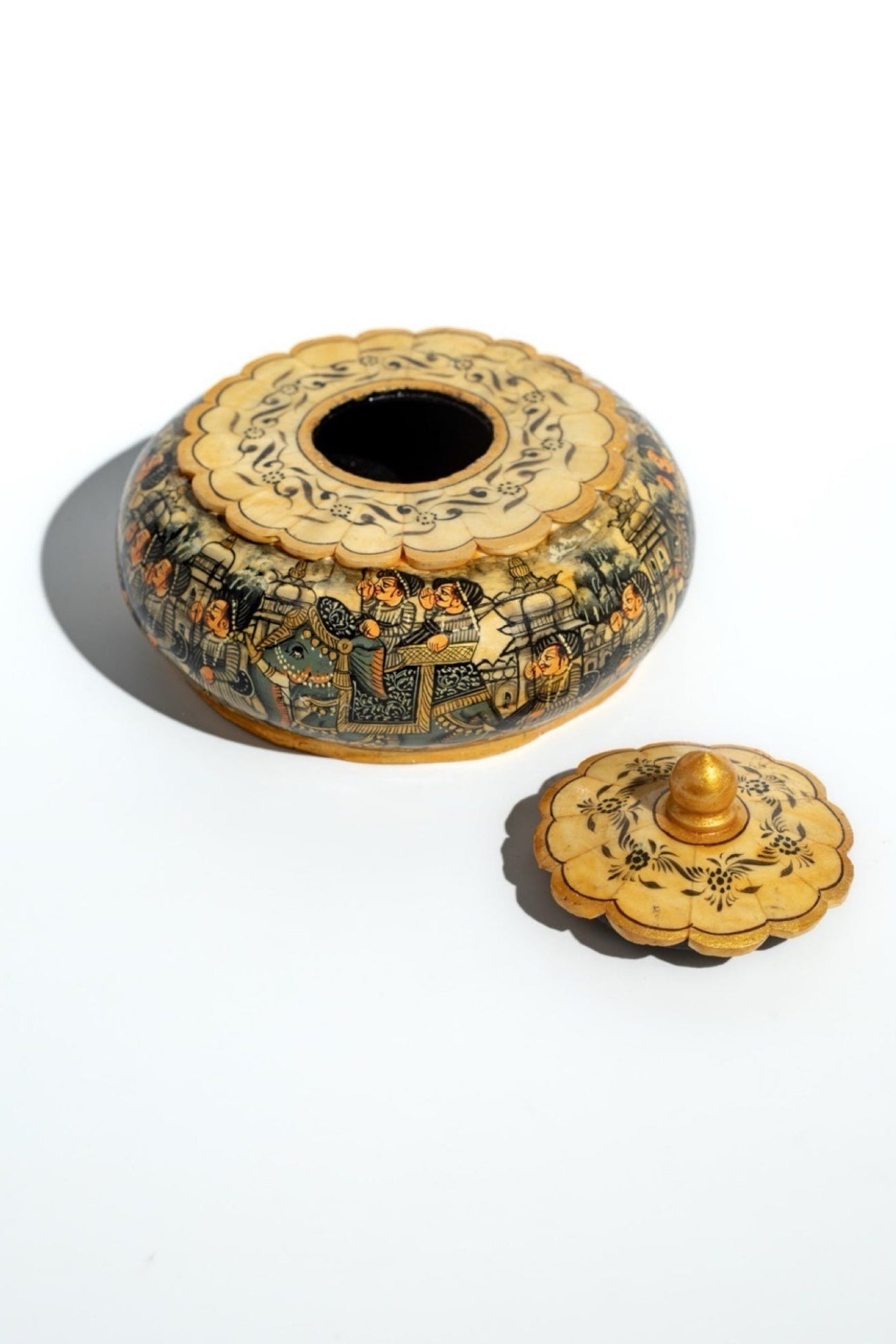 Decorative hand painted bone box with lid on a white background