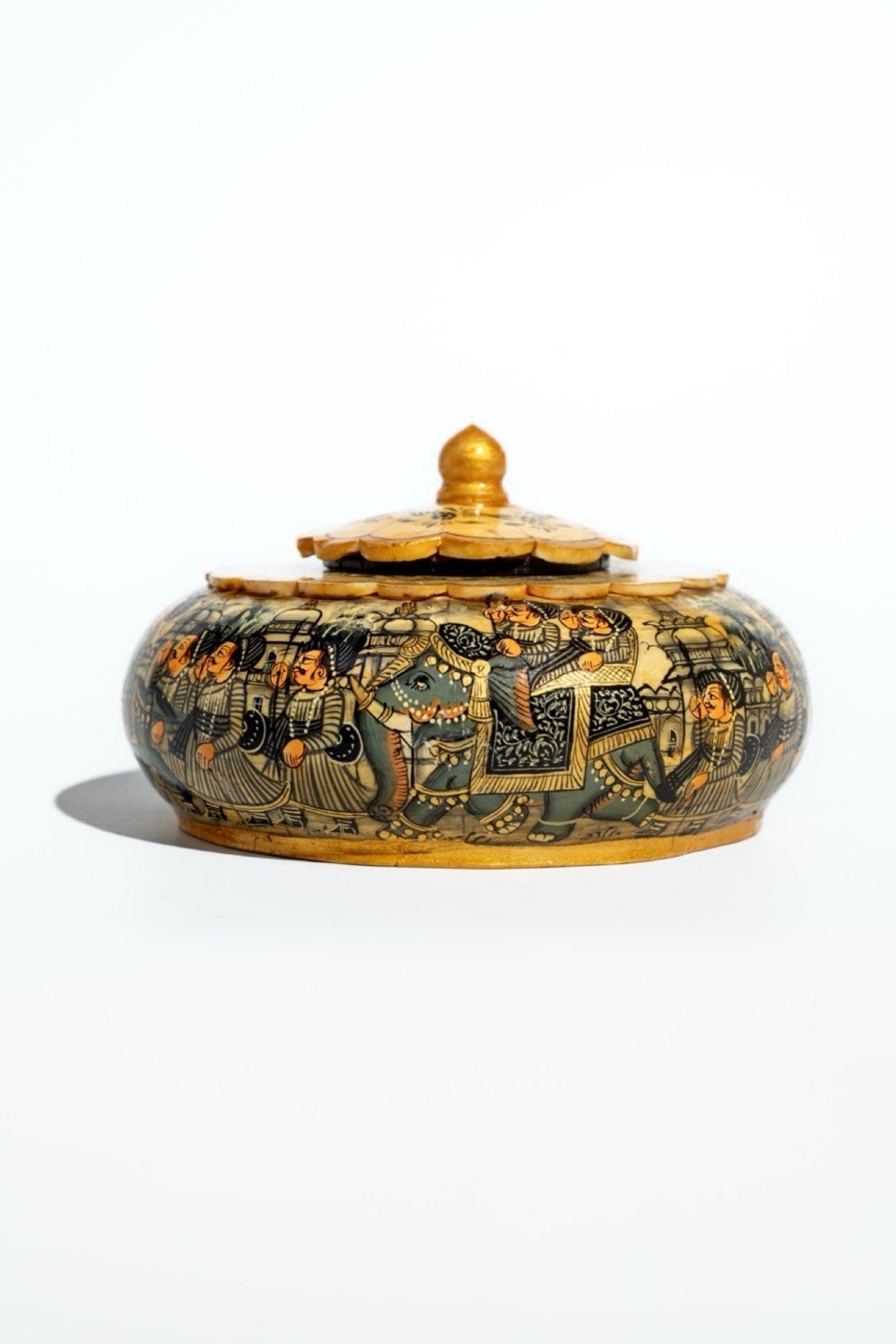 Decorative ceramic jar with intricate designs on a white background